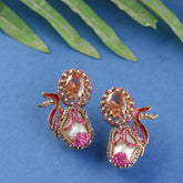 Pair of ornate earrings pink gemstones