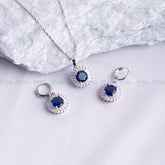 Silver jewelry set with blue stones on a white background