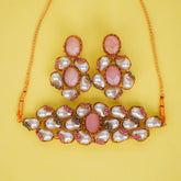 Jewelry set with pink and white stones on a yellow background