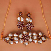 Jewelry set with necklace and earrings on a brown background