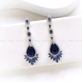 Pair of blue teardrop earrings on a white background