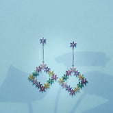 Multicolored floral earrings on a light blue background