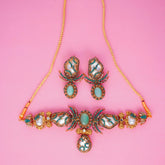 Jewelry set with necklace and earrings on a pink background