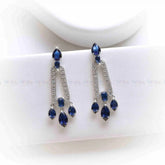 Pair of dangling earrings with emerald blue gemstones