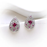 Teardrop-shaped earrings with pink gemstones on a white background