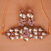 Jewelry set with necklace and earrings on a brown background