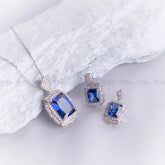 Jewelry set with blue gemstones on a white fabric background