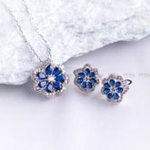 Jewelry set with blue flower-shaped stones on a white background