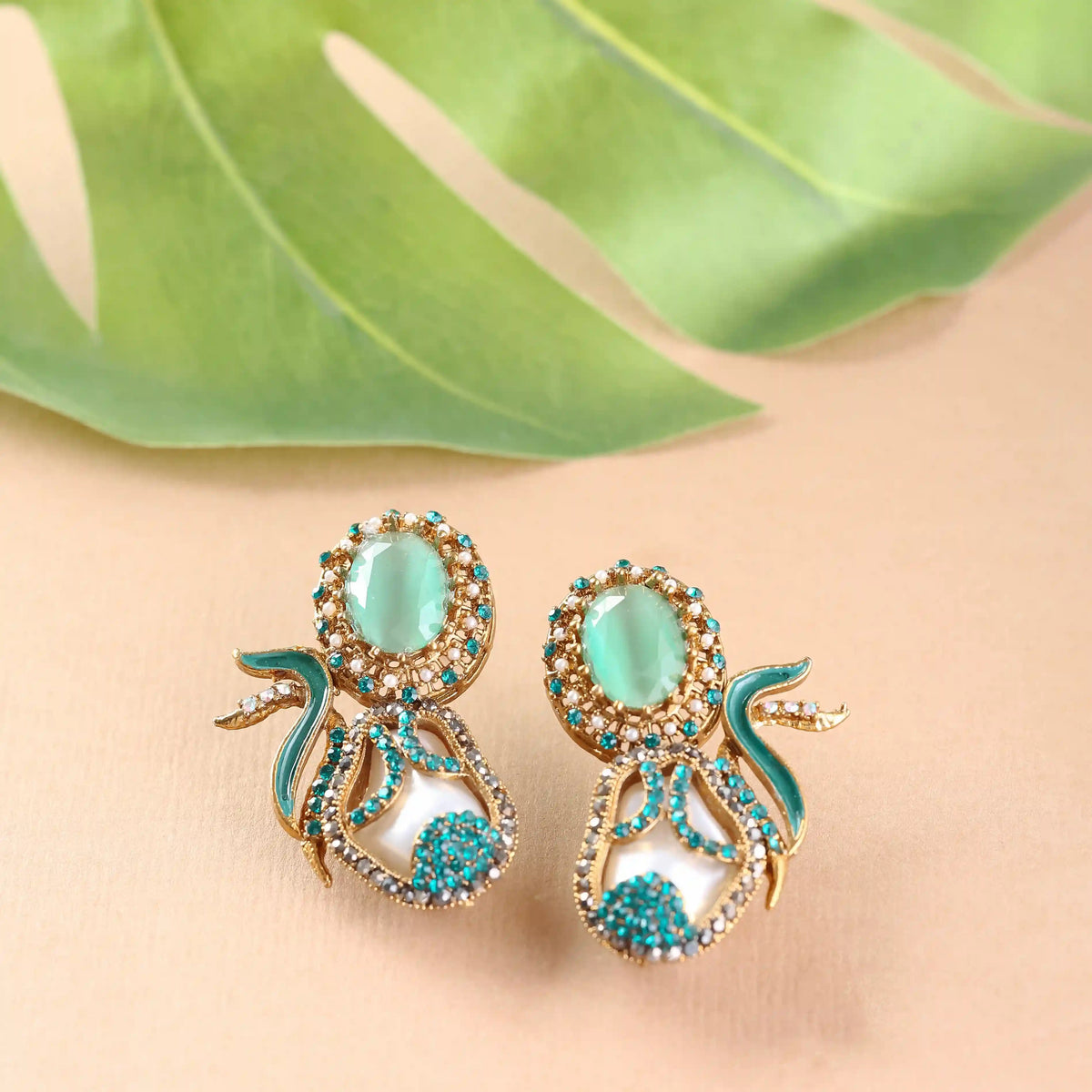 Pair of ornate earrings with turquoise stones