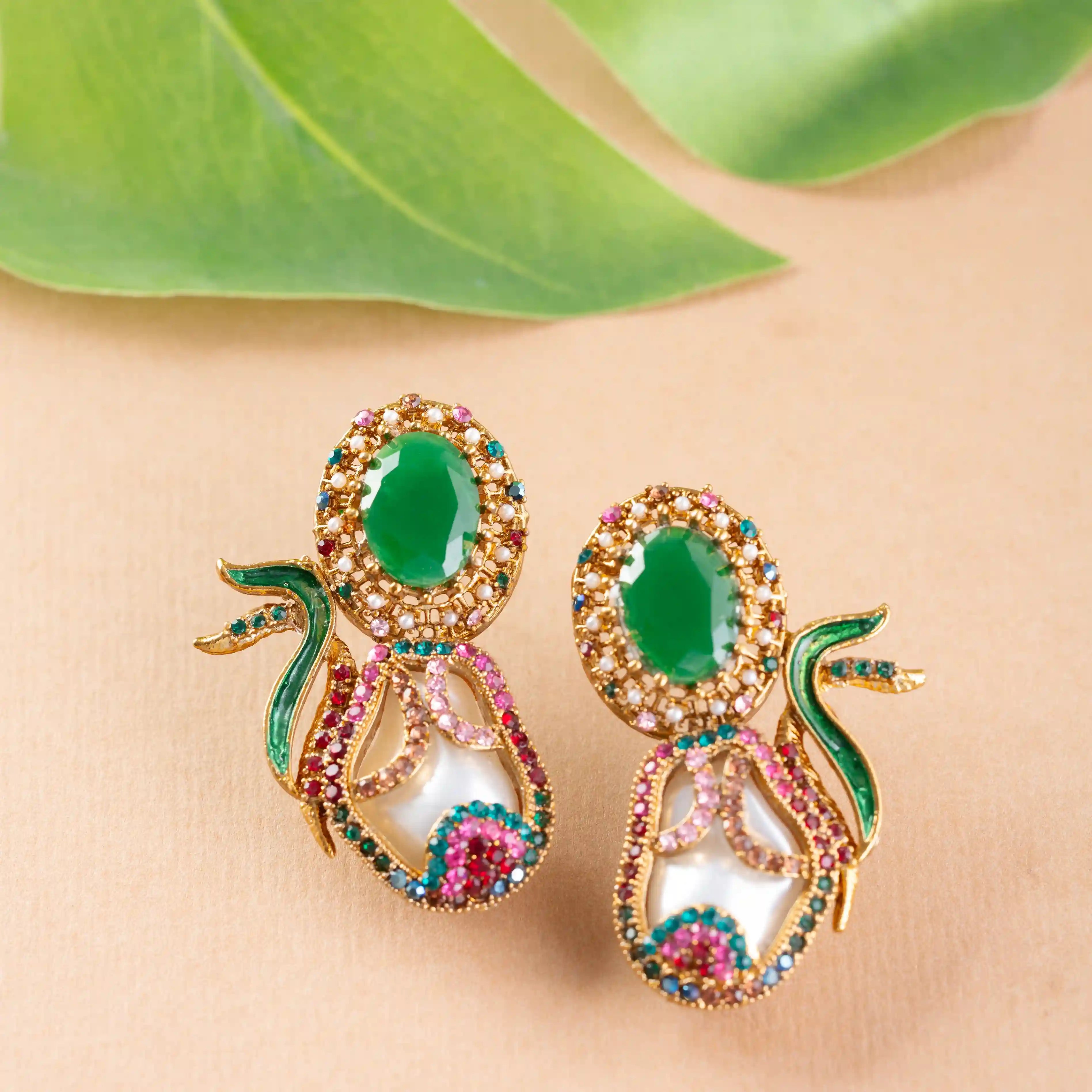 Ornate earrings with green gemstones and gold