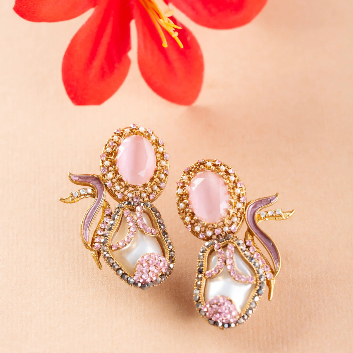 Ornate earrings with pink stones