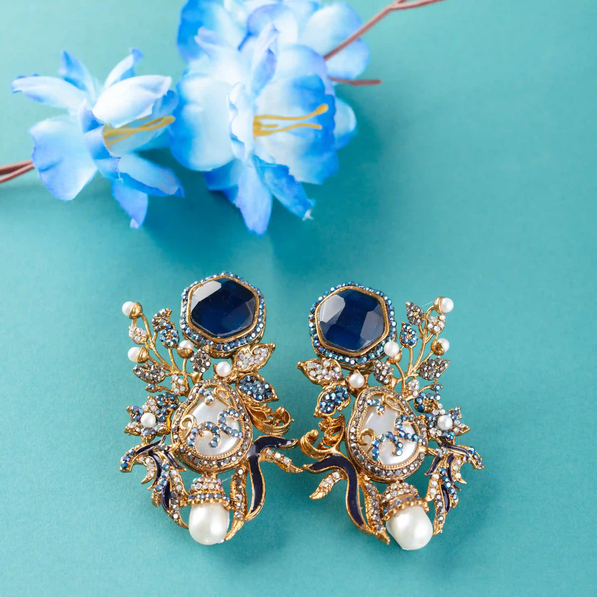 Ornate gold and blue earrings with pearls
