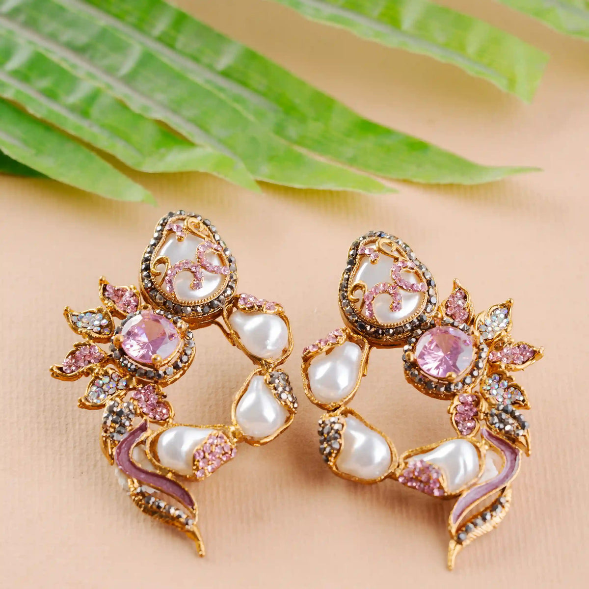 Ornate earrings with pink gemstones and pearls