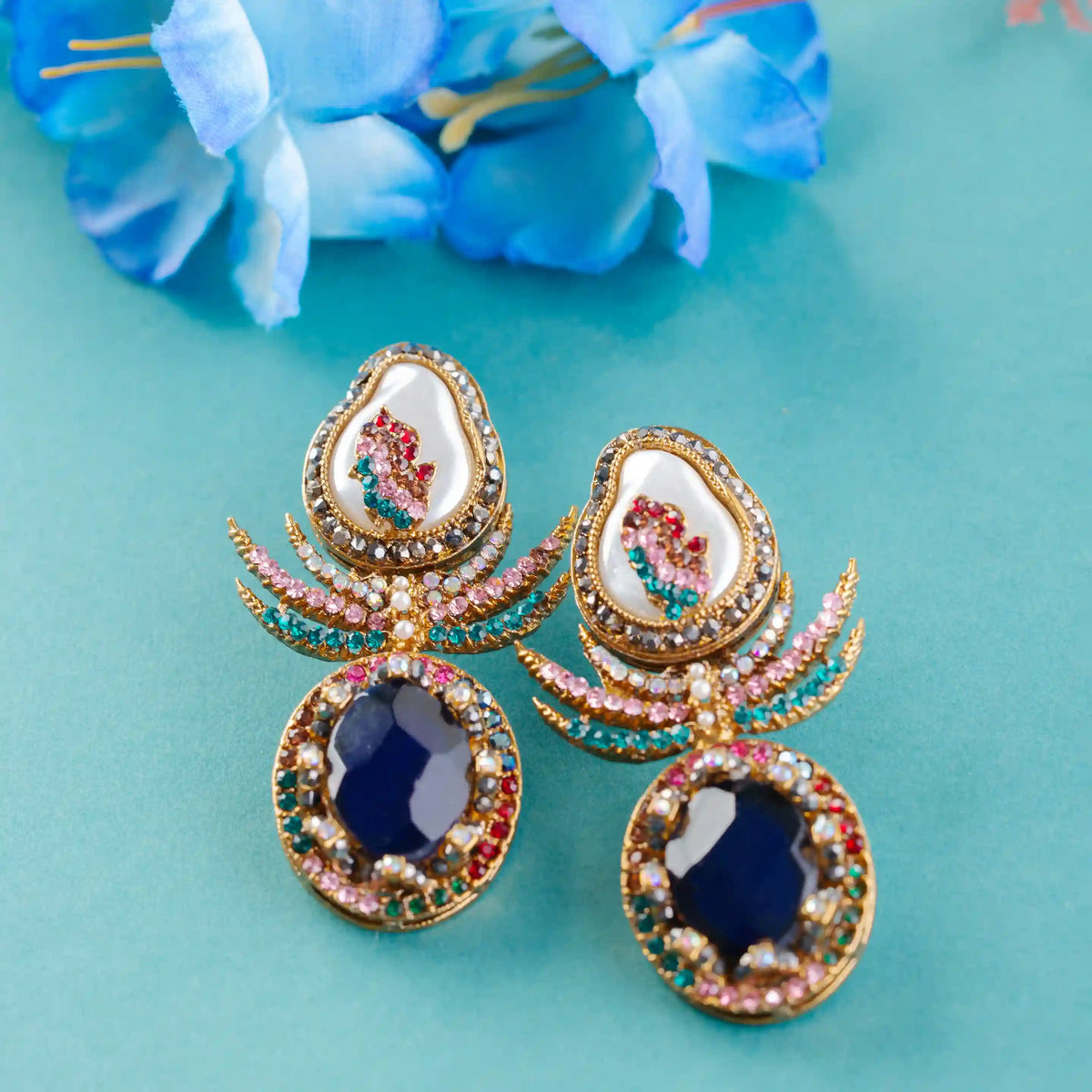 Ornate earrings with blue stones