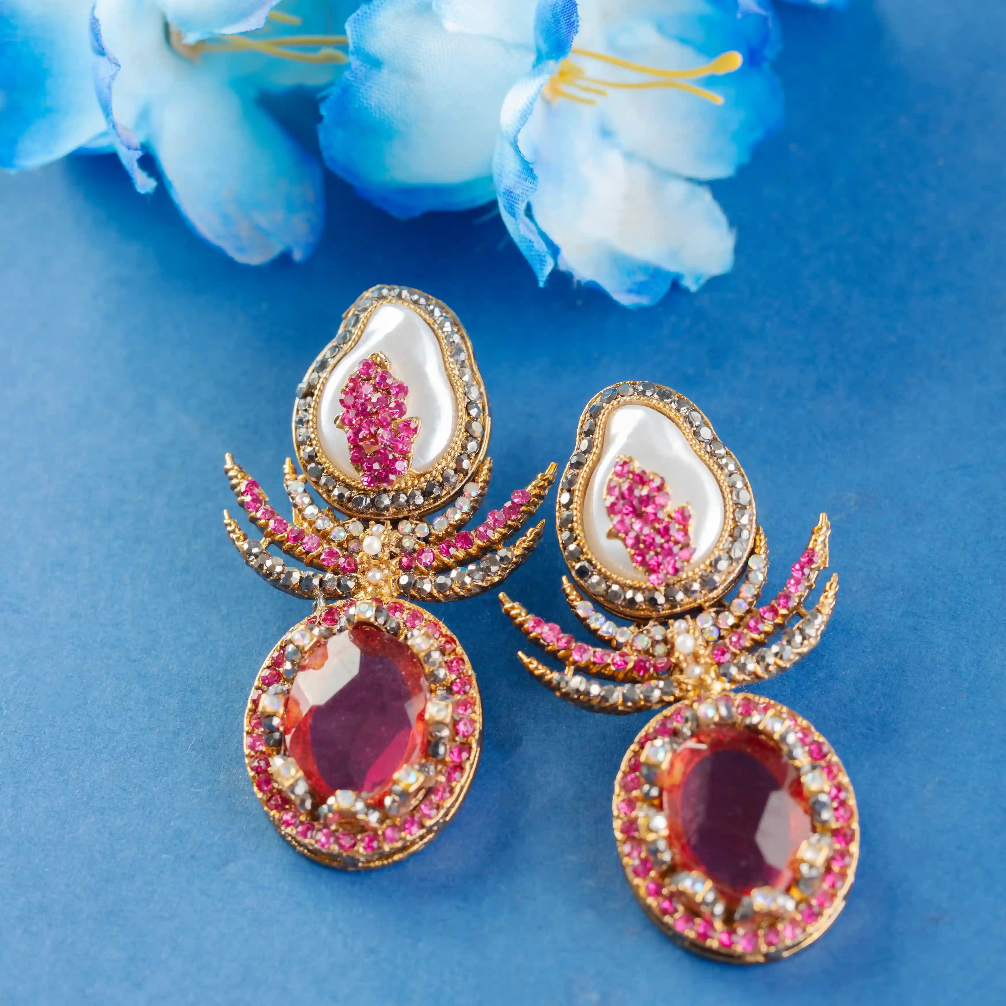 Ornate earrings with red and pink gemstones
