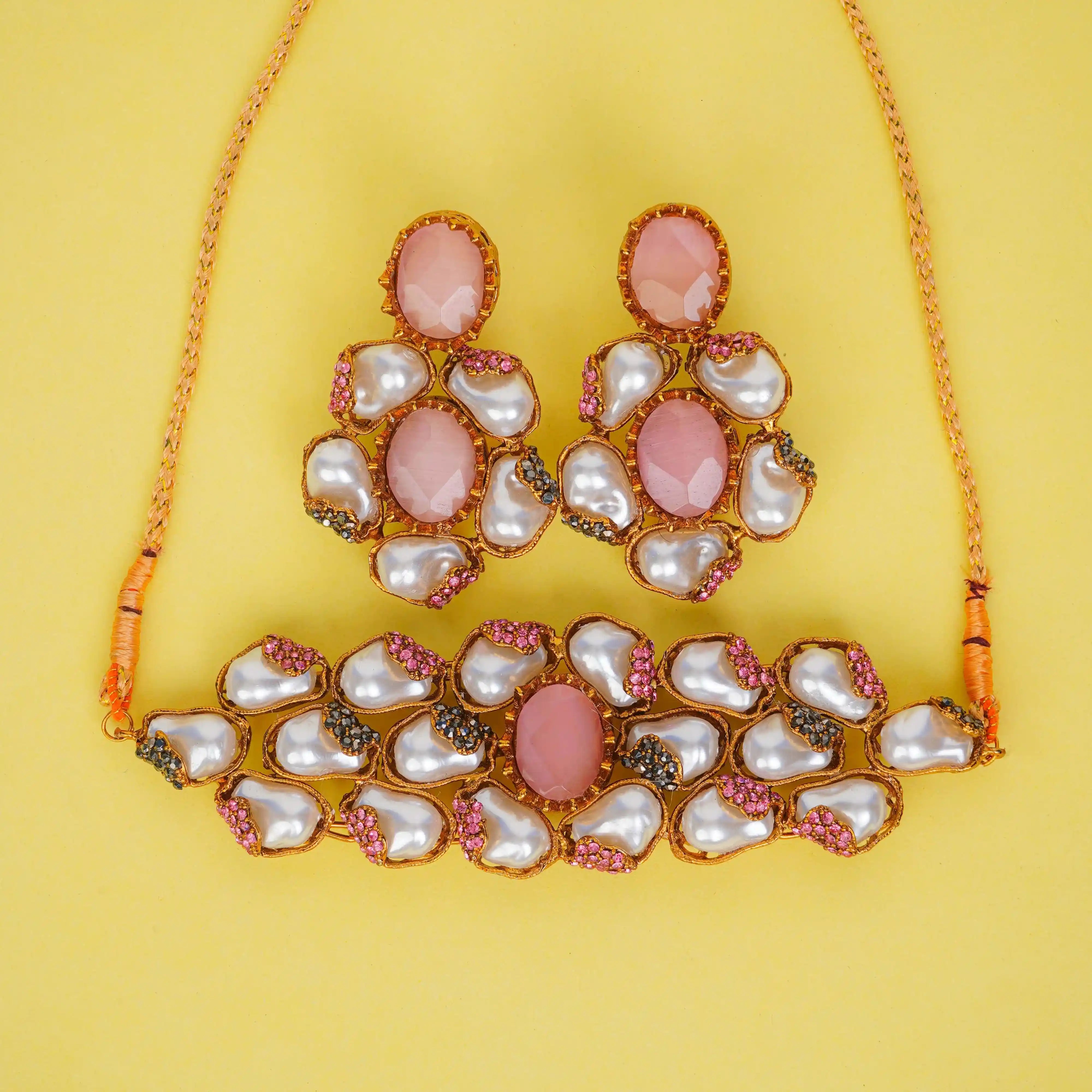 Jewelry set with pink and white stones on a yellow background
