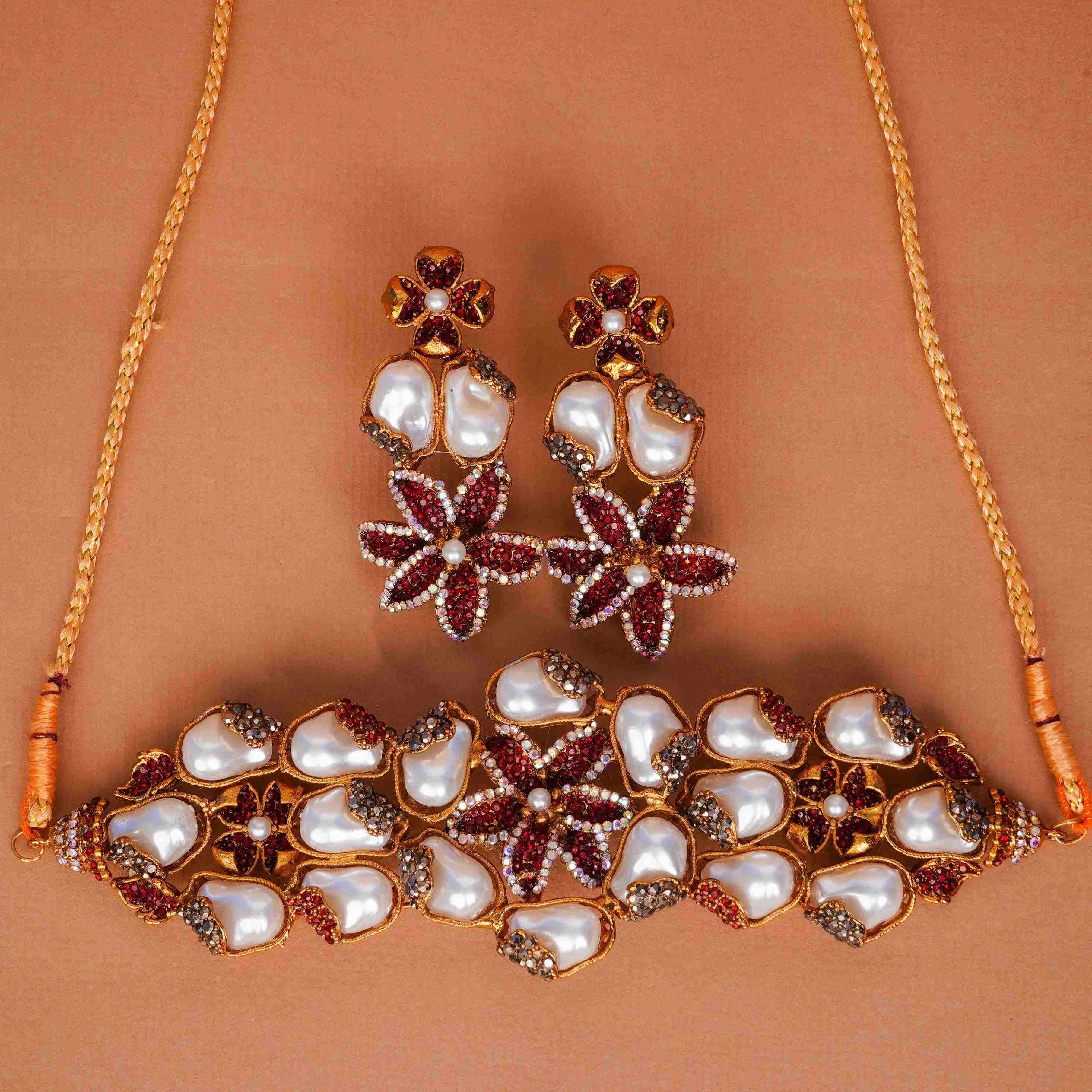 Jewelry set with necklace and earrings on a brown background