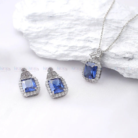 Jewelry set with blue gemstones on a white background