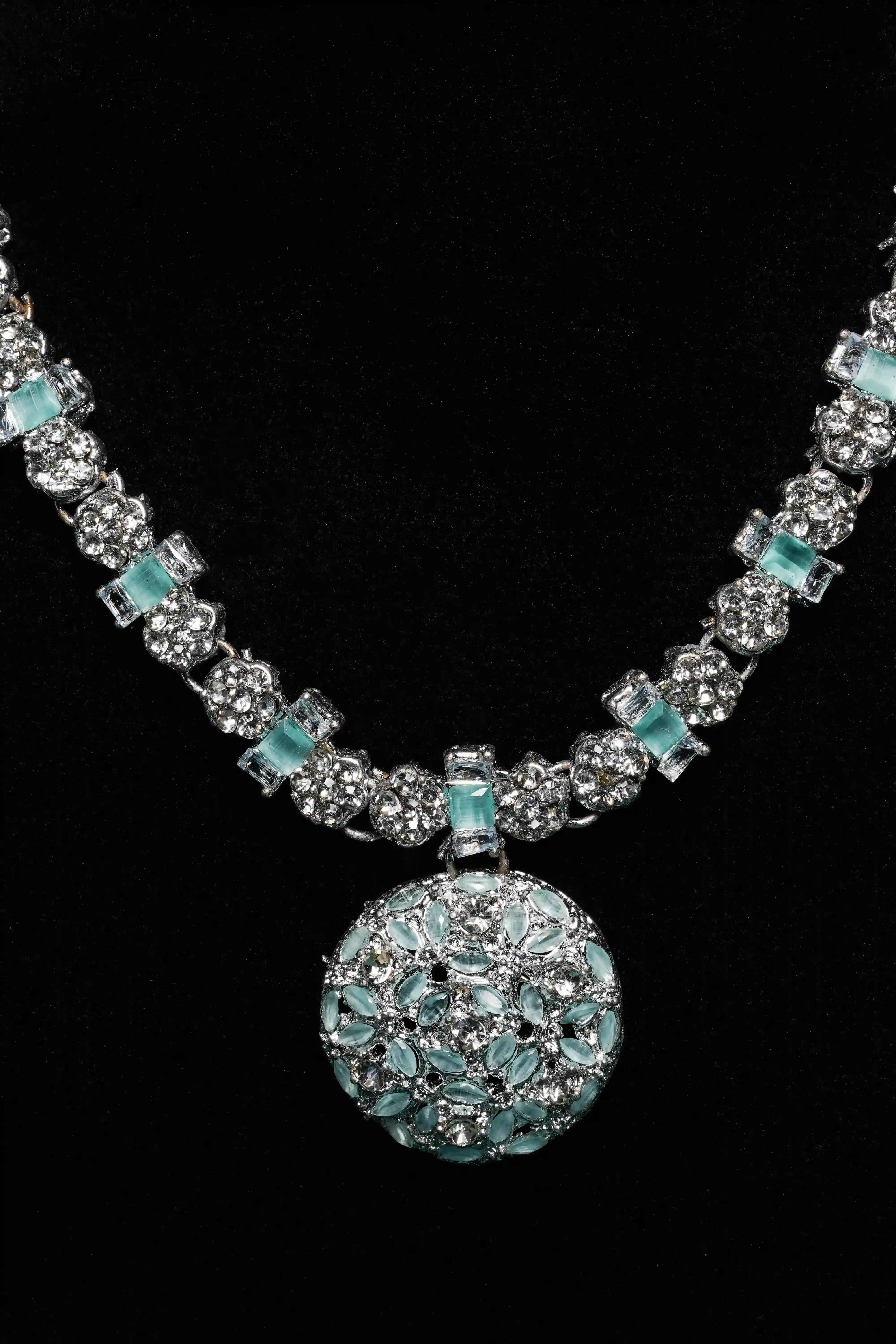 Necklace with turquoise and silver beads on a black background