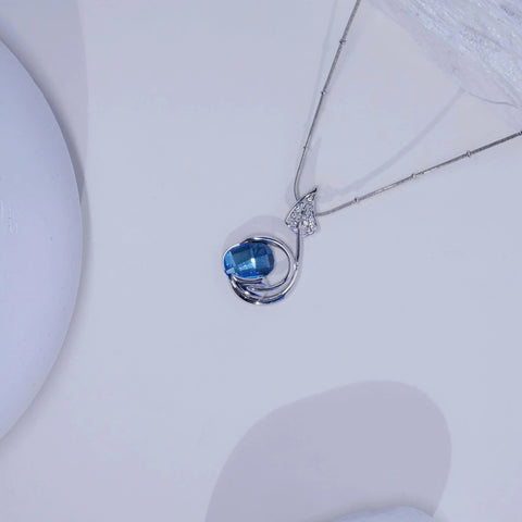 Silver necklace with a blue gemstone pendant