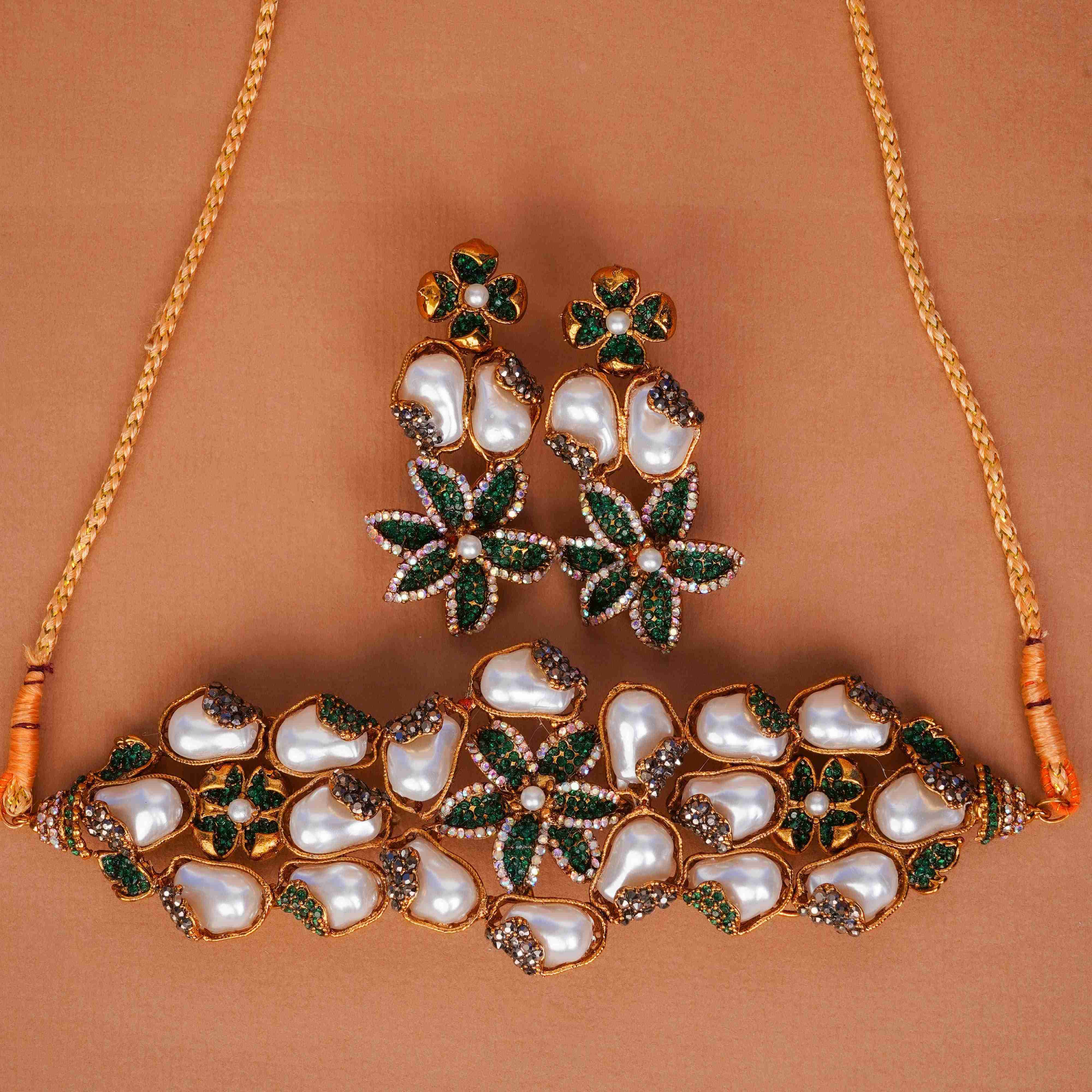 Jewelry set with necklace and earrings on a brown background