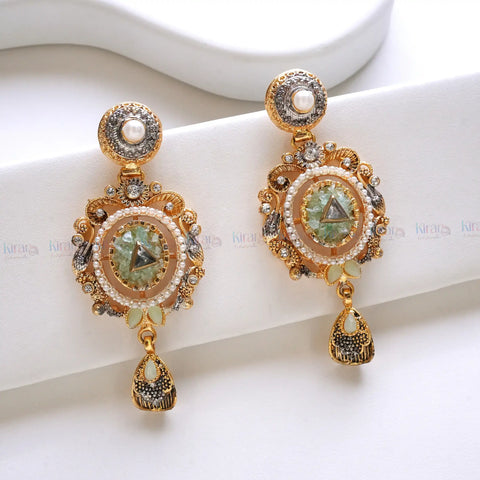 Pair of ornate gold earrings with gemstones