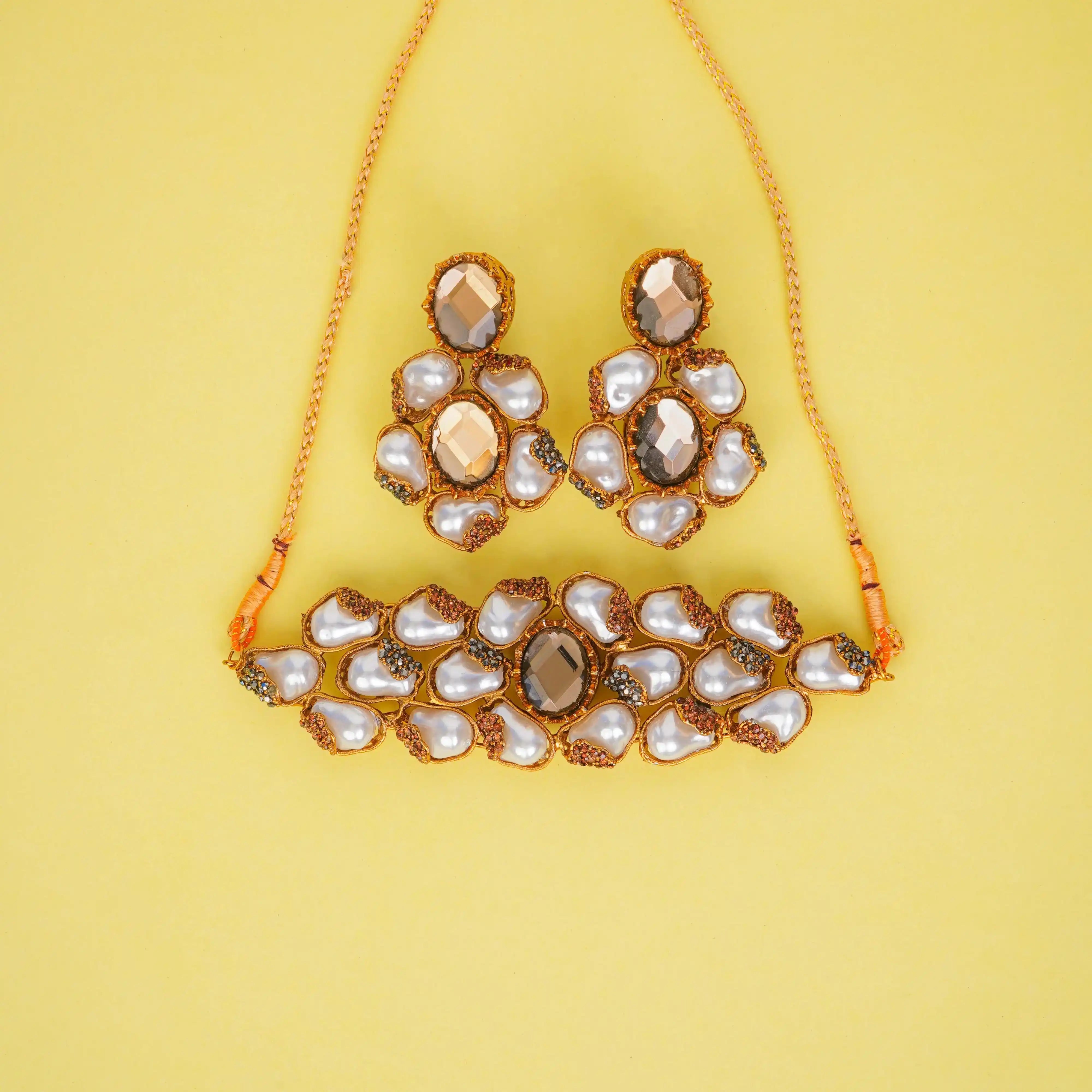 Jewelry set with necklace and earrings on a yellow background