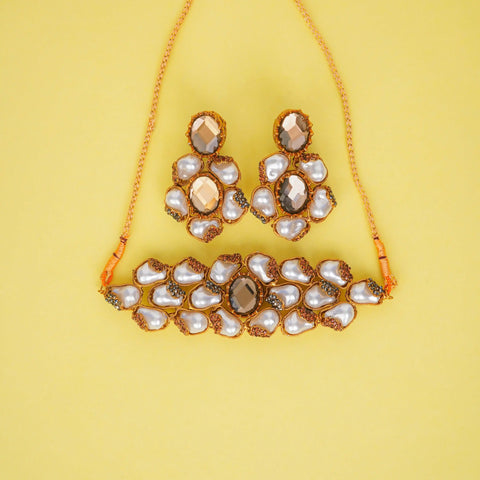 Jewelry set with necklace and earrings on a yellow background