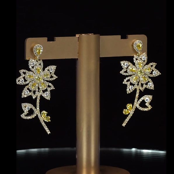 Floral earrings with gemstones on a black background