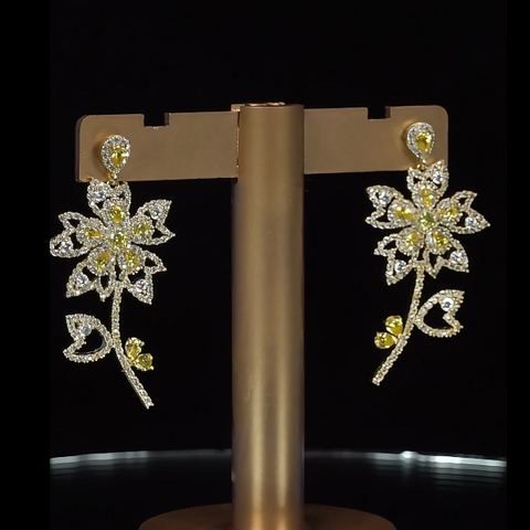 Floral earrings with gemstones on a black background