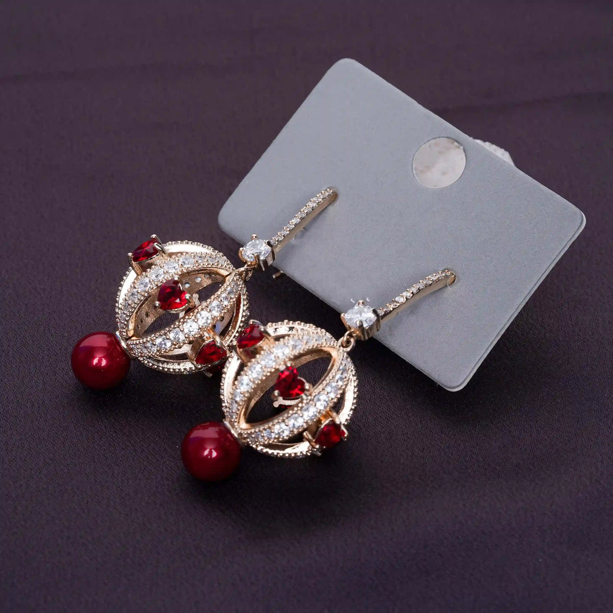 Gold earrings with red gemstones