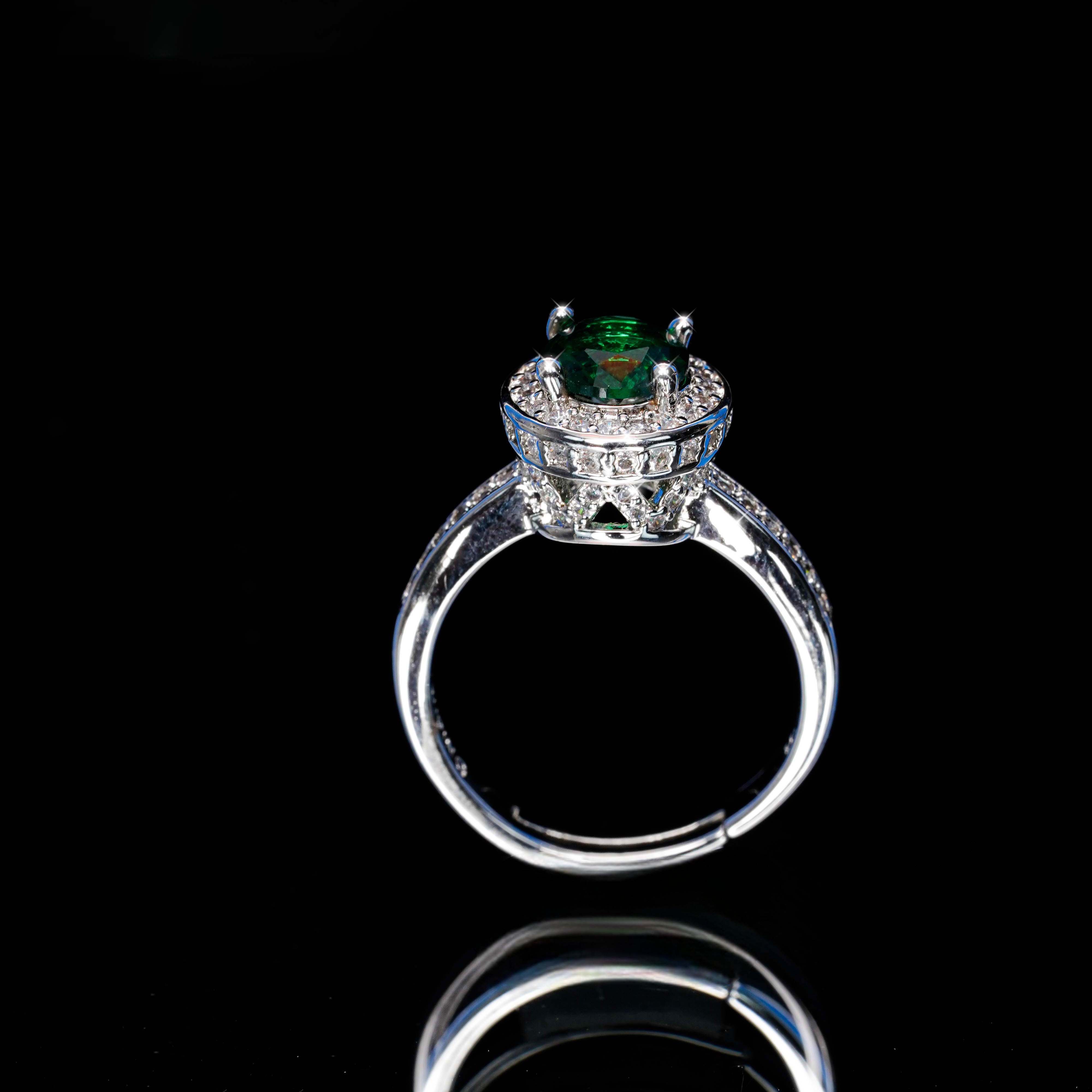 Diamond ring with a green gemstone