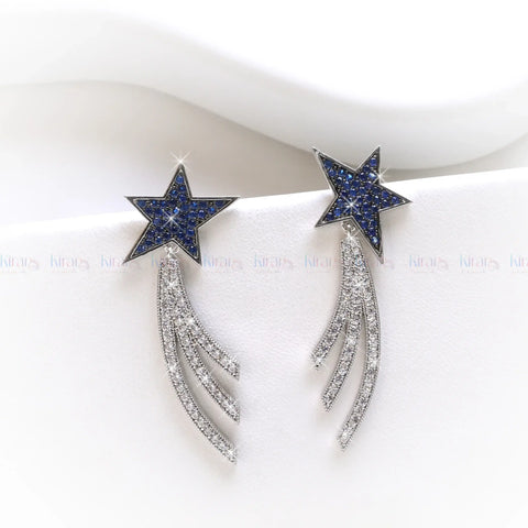 Star-shaped earrings with blue gemstones and silver accents on a white background