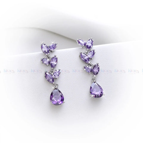 Pair of purple teardrop earrings on a white background