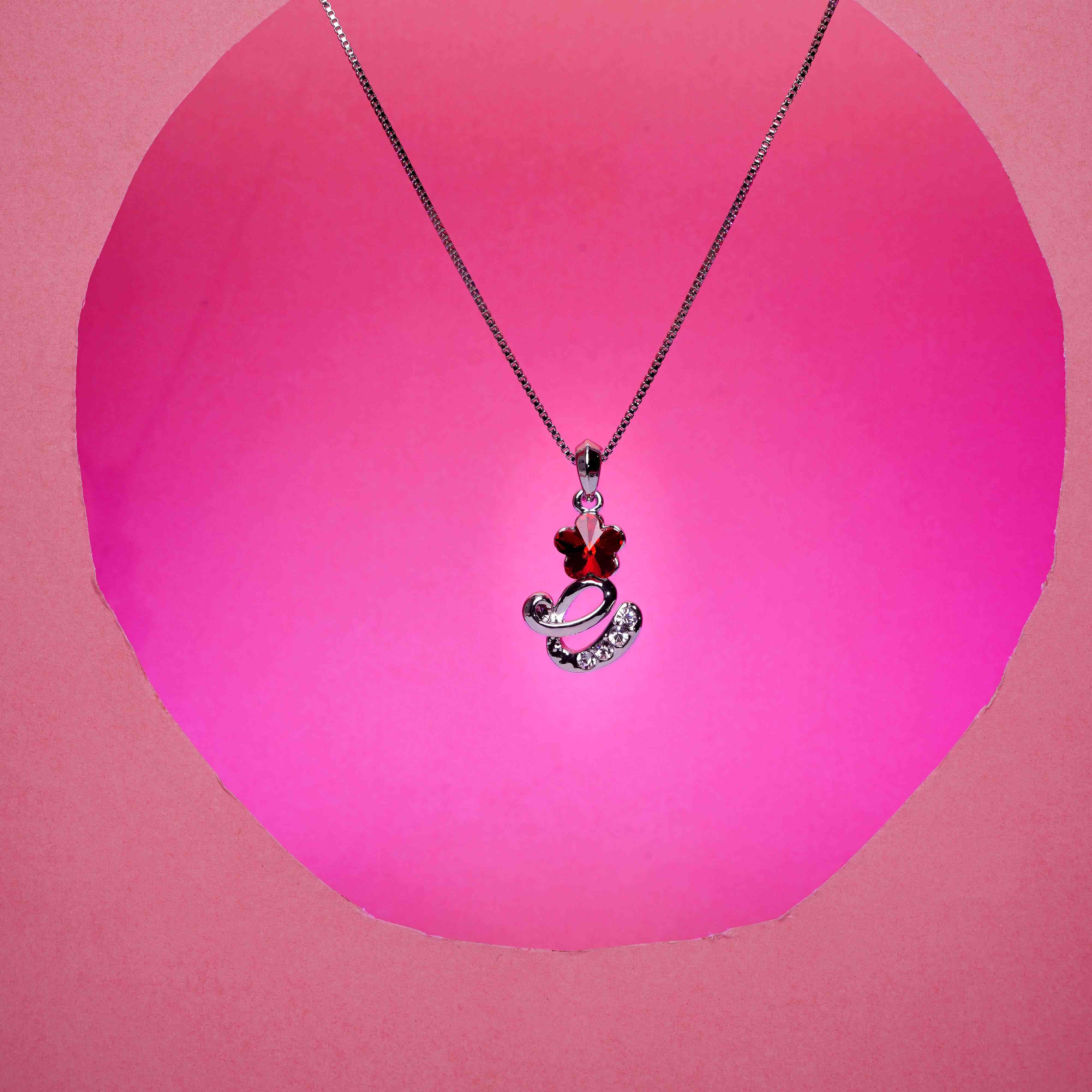 Necklace with a heart-shaped pendant on a pink background
