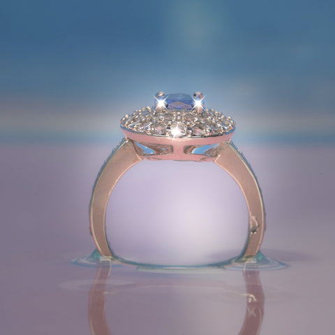 Rose gold ring with a diamond on a reflective surface