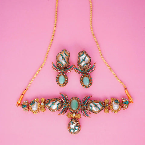 Jewelry set with necklace and earrings on a pink background