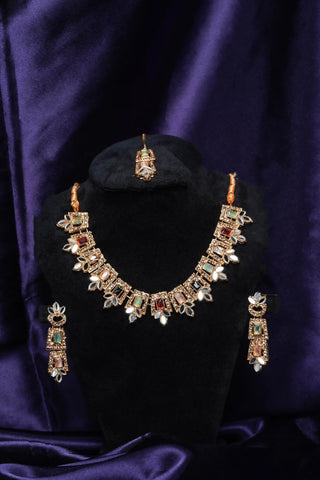 Ornate necklace and earrings set on a black stand