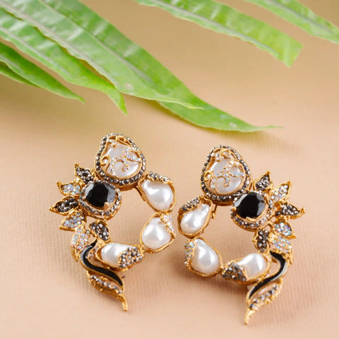 Pair of ornate earrings with pearls and gemstones