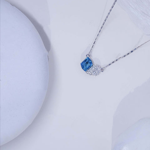Necklace with a blue pendant on a white background