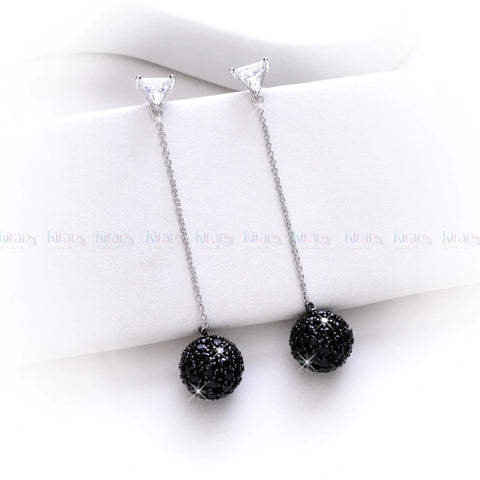 Black beaded necklace with silver chain on a white surface