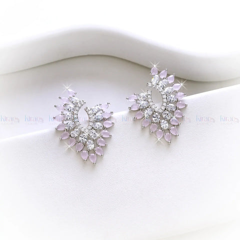Pair of earrings with pink gemstones and clear stones on a white background