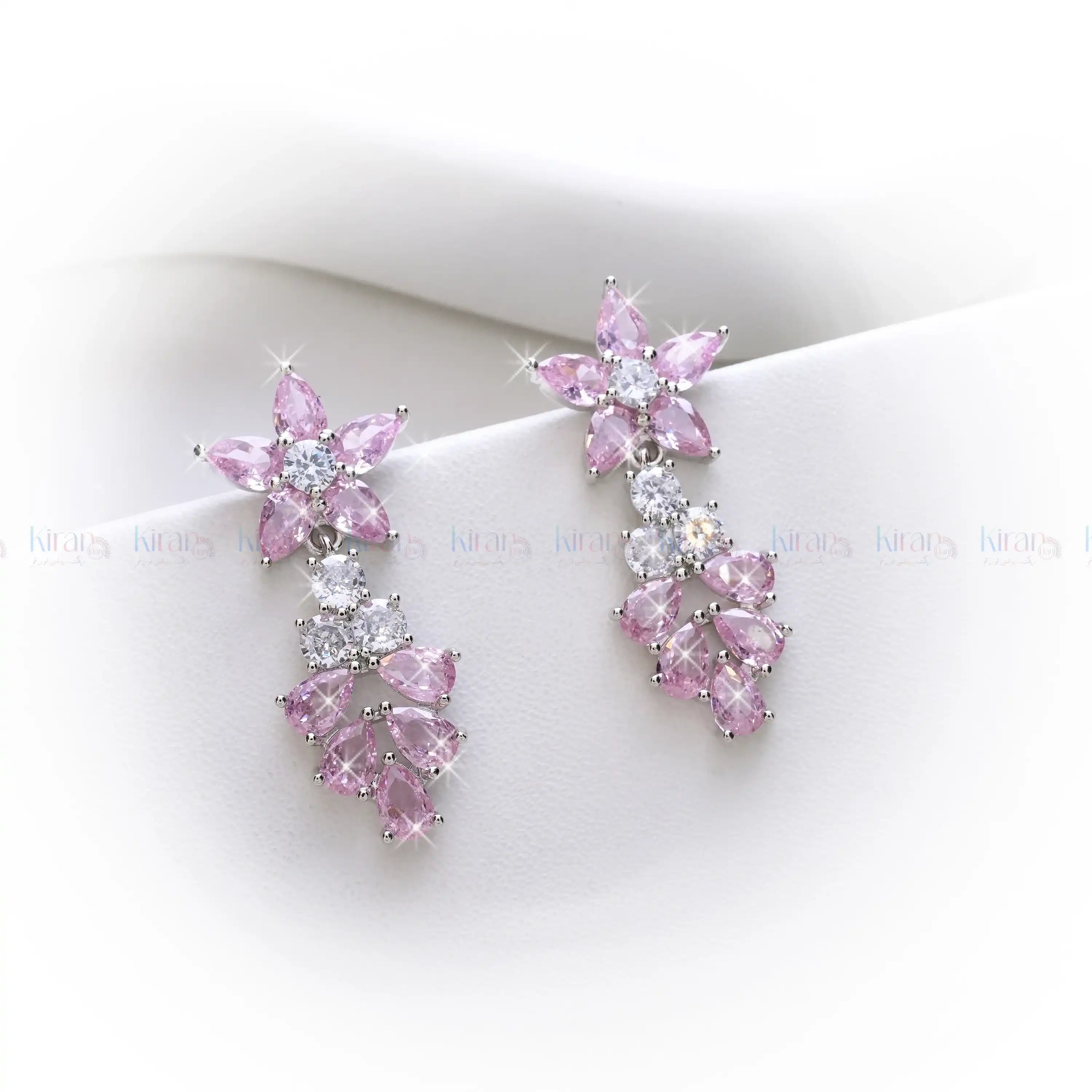 Pink and clear crystal earrings on a white background