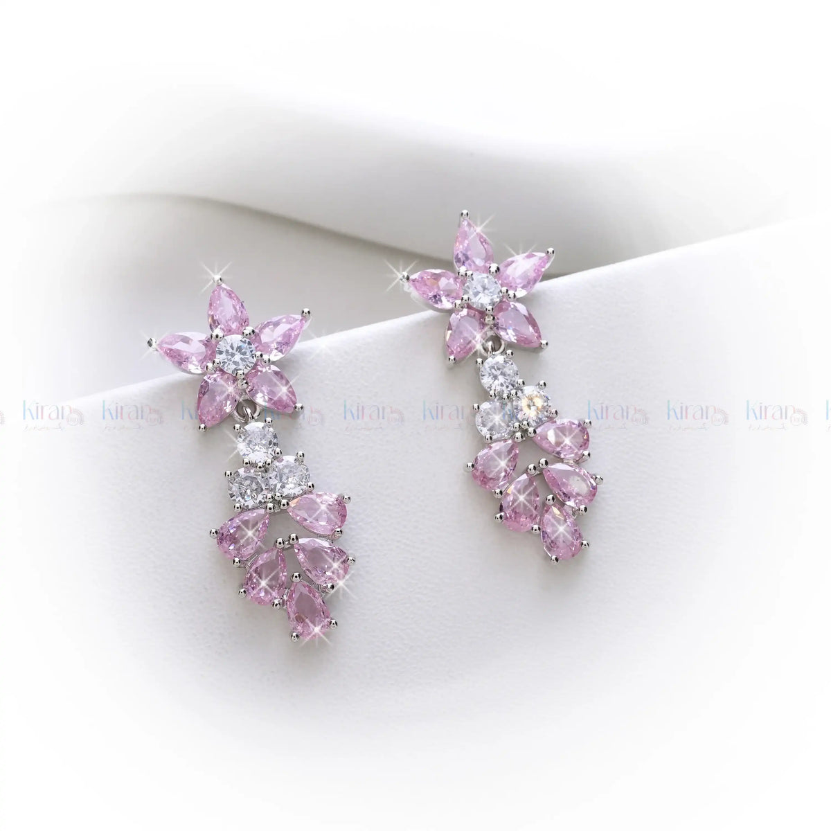 Pink and clear crystal earrings on a white background