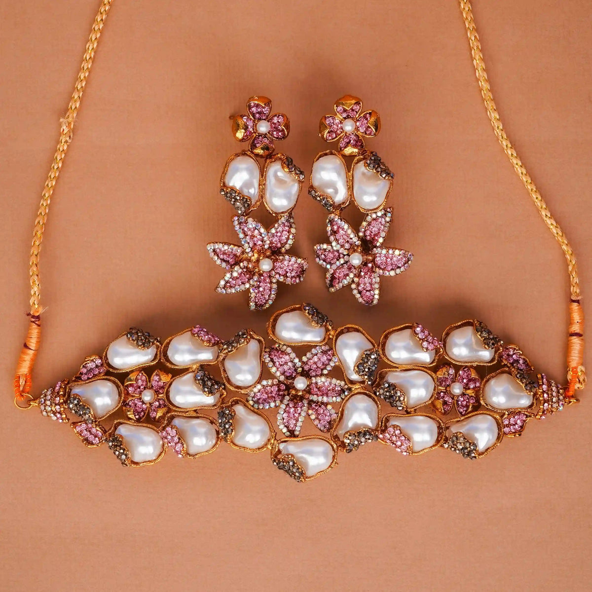 Jewelry set with necklace and earrings on a brown background