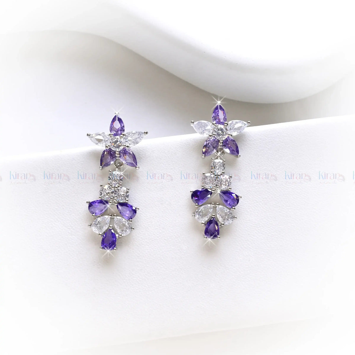 Purple gemstone earrings on a white background