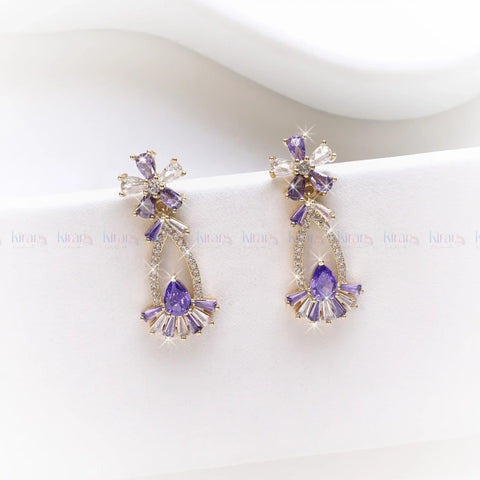 Purple earrings with gold accents on a white background