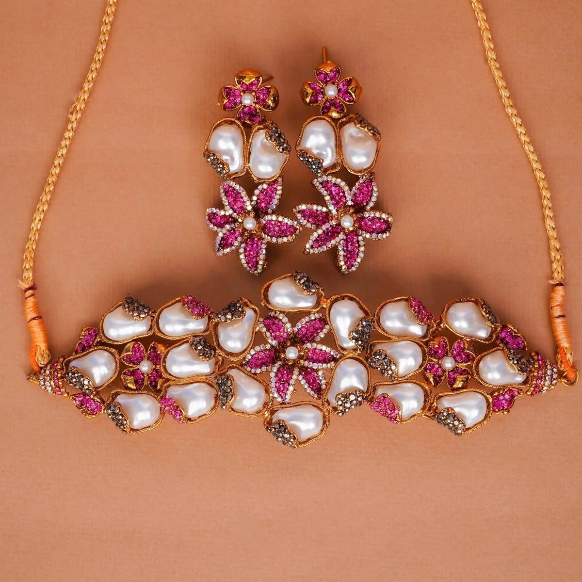 Jewelry set with necklace and earrings on a brown background