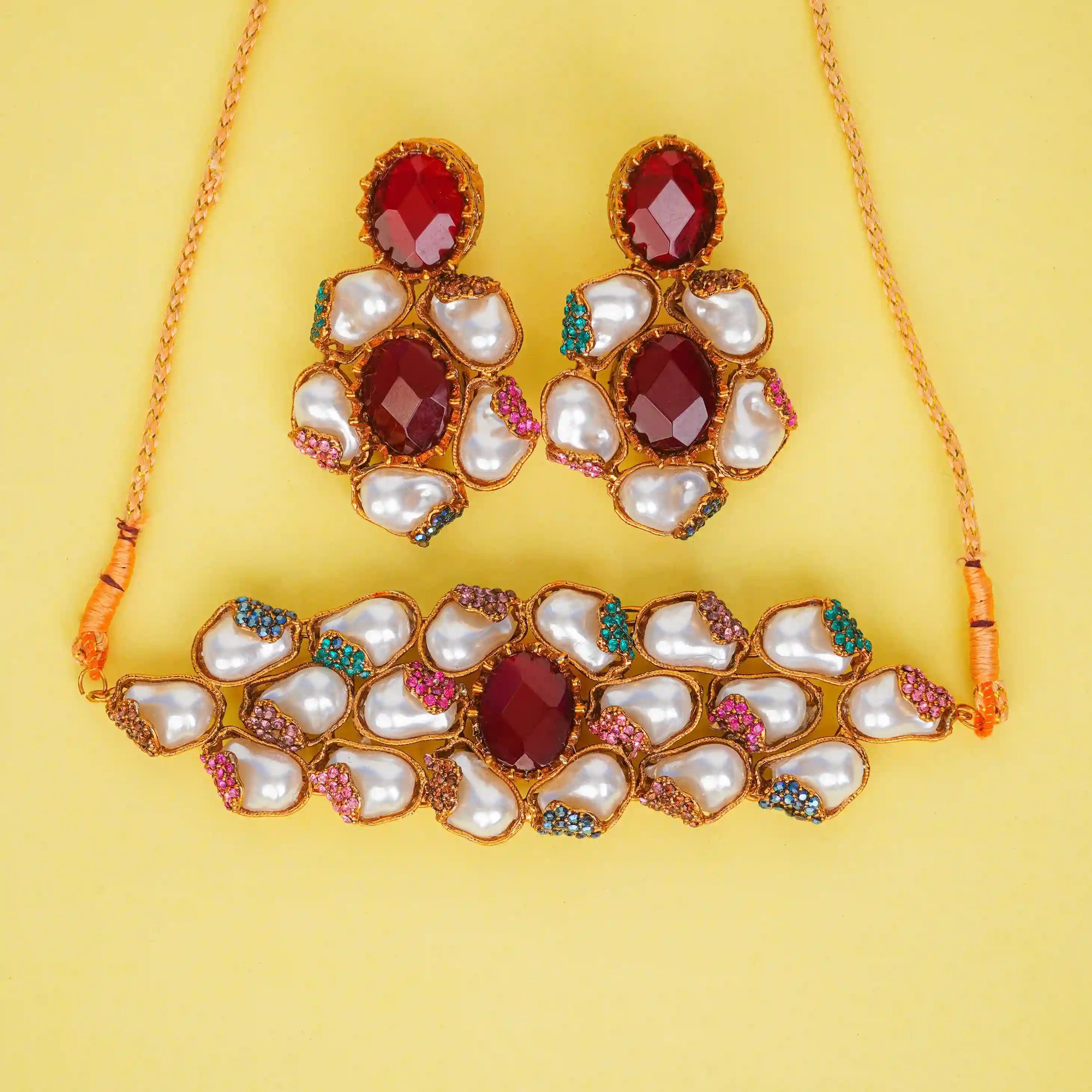 Jewelry set with necklace and earrings on a yellow background