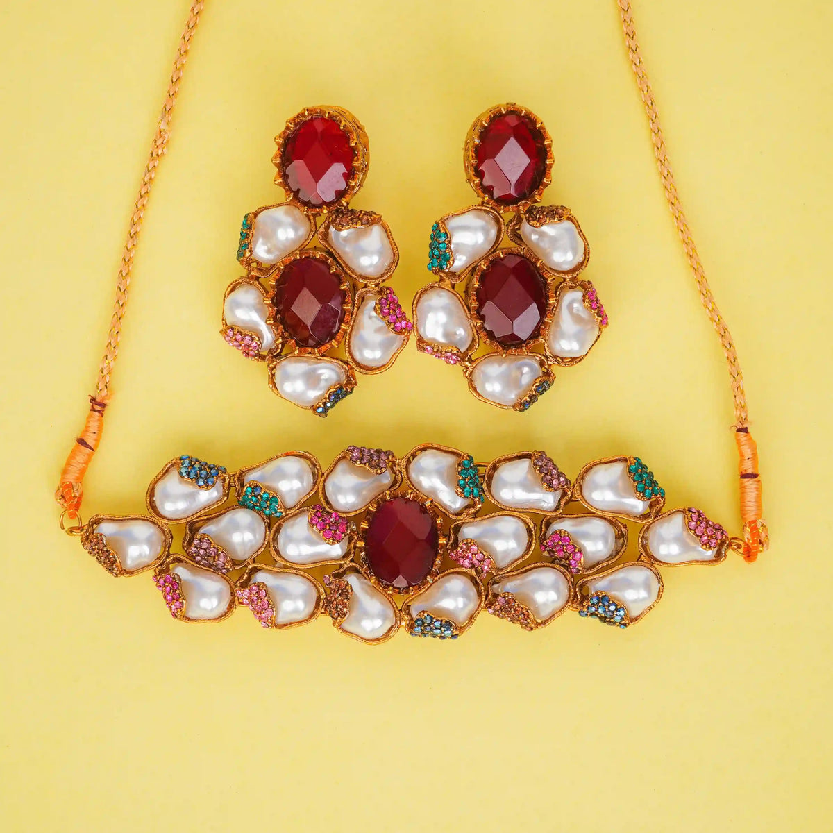 Jewelry set with necklace and earrings on a yellow background